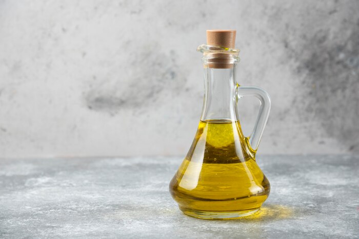 Olive oil bottle on marble table.