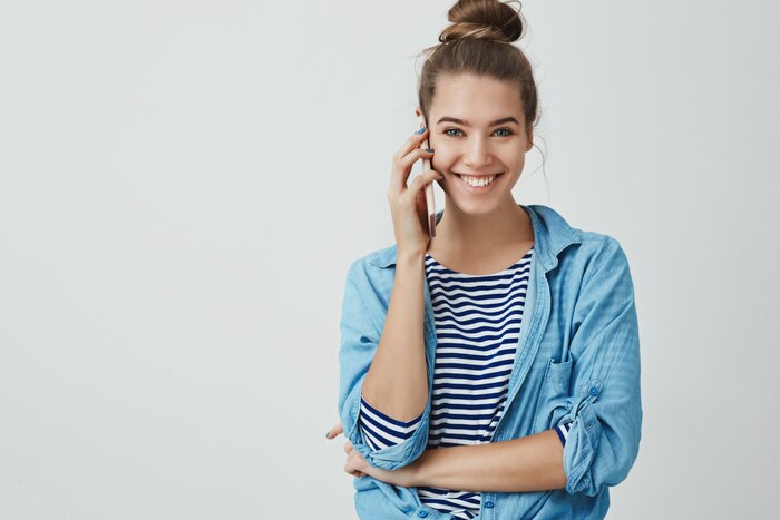 Happy excited attractive young woman talking by phone