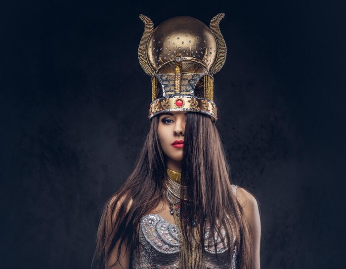 Portrait of haughty egyptian queen in an ancient pharaoh costume. isolated on a dark background.