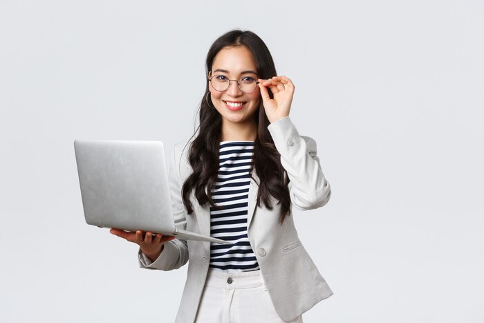 Business, finance and employment, female successful entrepreneurs concept. confident smiling asian businesswoman, office worker in white suit and glasses using laptop, help clients
