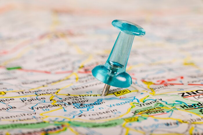 Turquoise colored pushpin stucked in world map