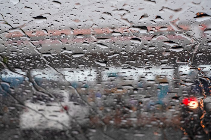 Picture inside water rain drops on car window glass