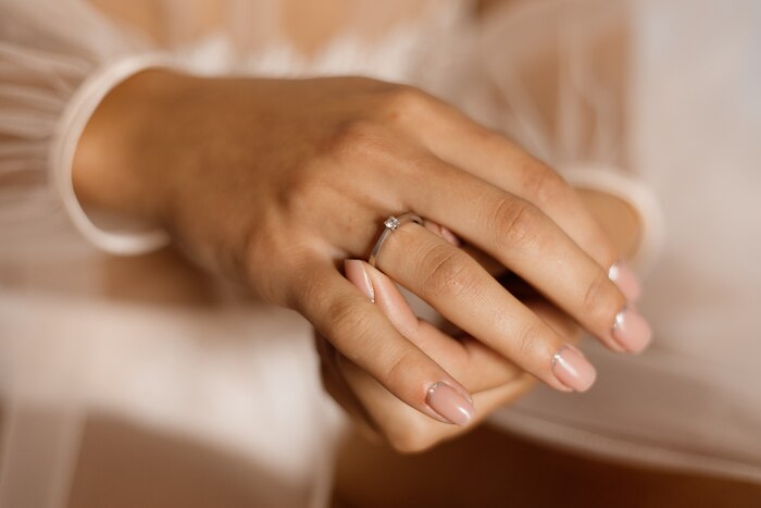 Woman with engagement ring with diamond and beautiful manicure