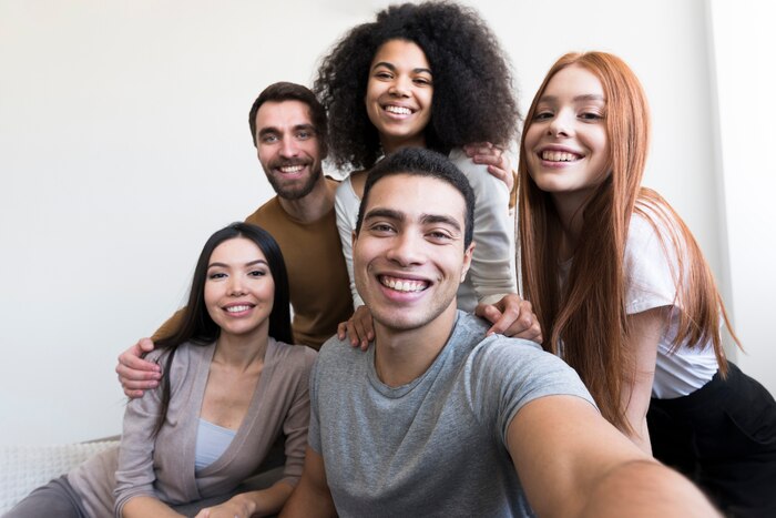 Group of happy young people taking a selfie