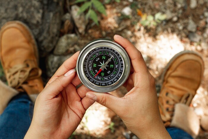 Top view woman holding compass