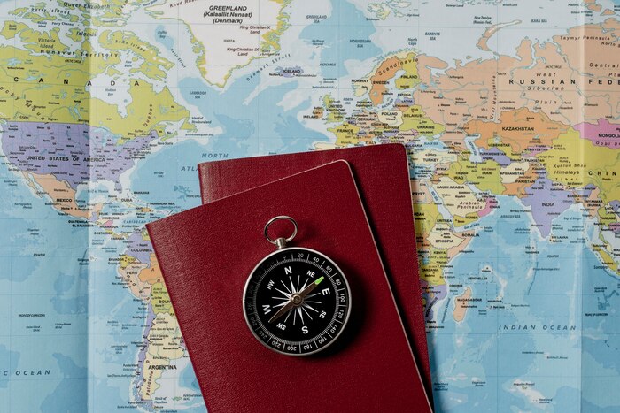View of world travel map with passports and compass
