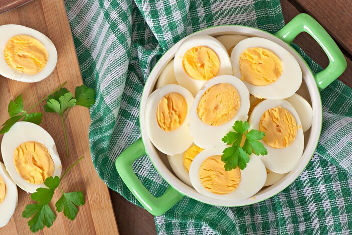 Boiled eggs in a bowl decorated with parsley leaves