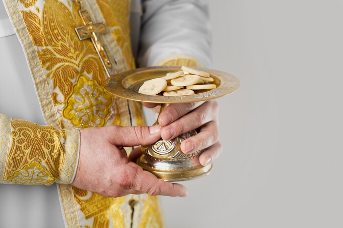 Holy communion concept with priest holding food