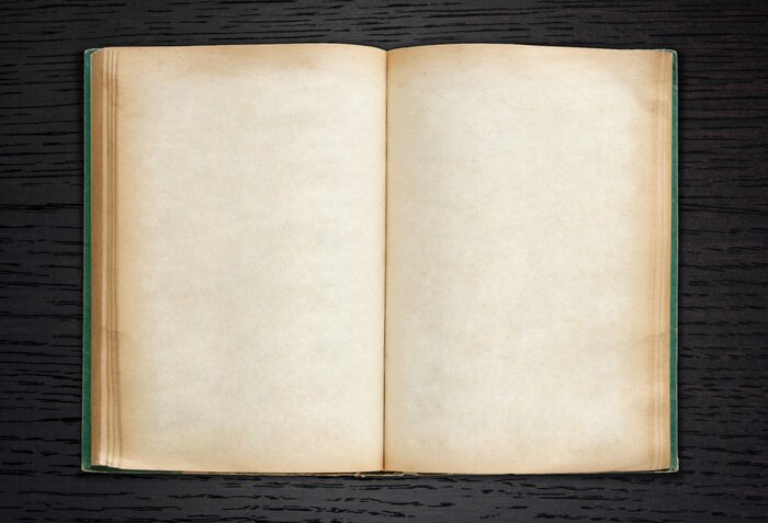 Old book open on dark wood background