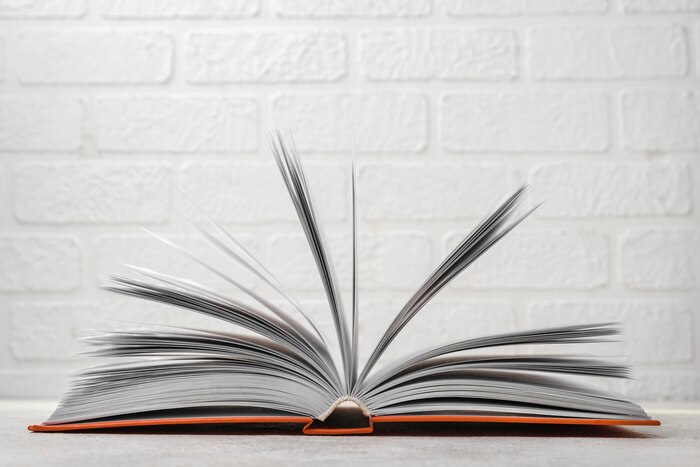 Front view of open hardback book on desk