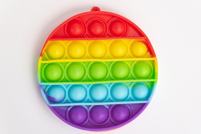 Colorful pop it toy over background - close up