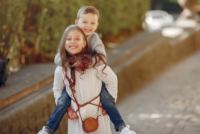 Cute little children with shopping bag in a city